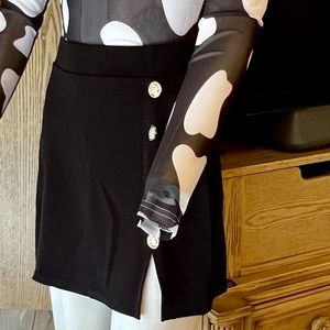 Women’s mini skirt black with gold tone buttons and a side slit. Pull on sz XS
